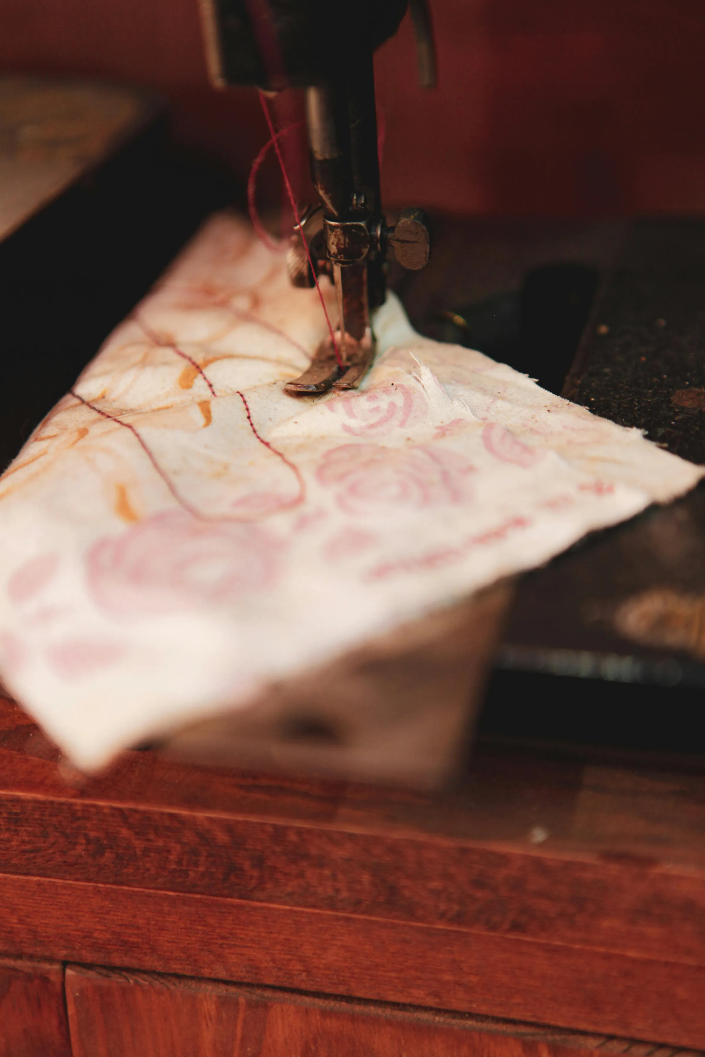 Fabric scraps being stitched into a new woven piece