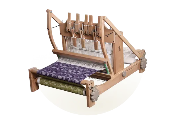 A compact eight-shaft table loom with a purple patterned weave