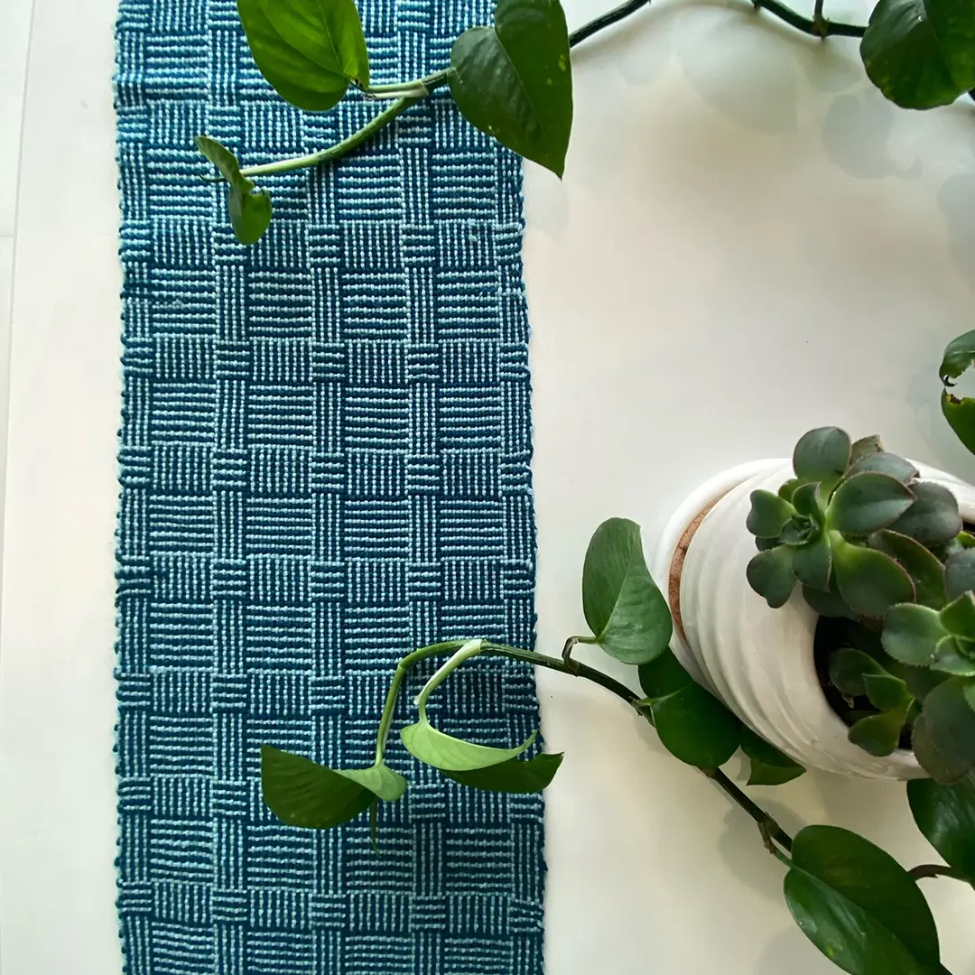 A blue basket-weave pattern woven on a multi-shaft loom