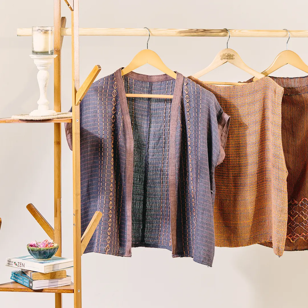 Garments made from handwoven fabric on a rail