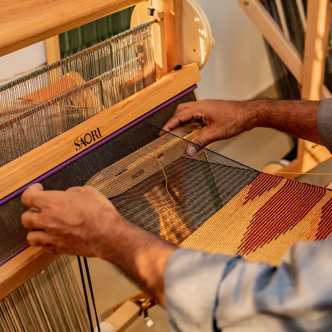 Weaving at a SAORI loom in a Weaving Spa session